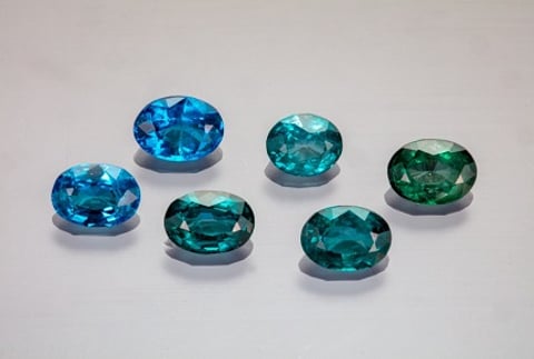 Suite of faceted nickel-diffused spinel (0.674–1.009 ct) showing the range of color from blue to bluish green. Photo by Aaron Palke and Diego Sanchez, ãGIA